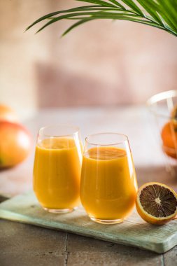 İki mango lassi ya da bardakta kesar süt. Hint sağIıklı ve mangolu soğuk bir içecek. Taze Lassi yoğurttan, sudan, baharatlardan, meyvelerden ve buzdan yapılır..