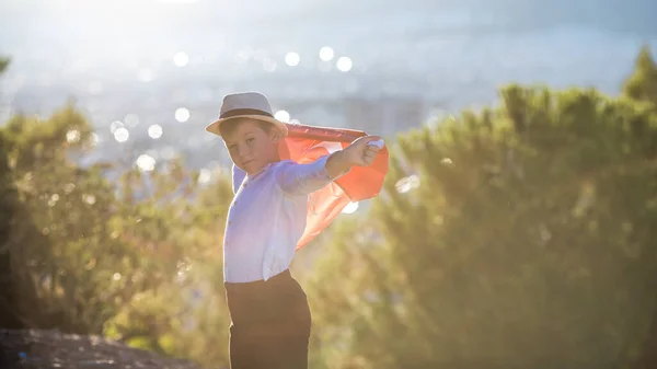 stock image Boy holding Turkey flag against city.  Kid hand waving Turkish flag view from back, copy space for text