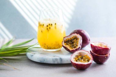 Pure passion, alcoholic cocktail with syrup, lime, orange juice, soda, ice and passion fruit