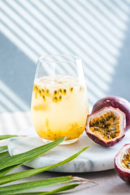 Pure passion, alcoholic cocktail with syrup, lime, orange juice, soda, ice and passion fruit