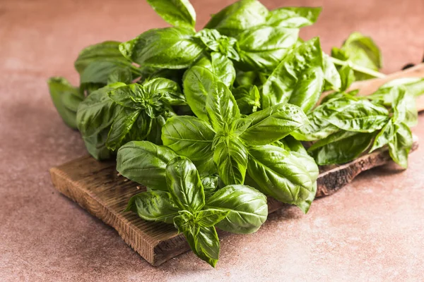 Fresh green sweet basil leaves, Also known as great basil or Genovese basil, Ocimum basilicum, a culinary herb in the mint family, and a tender plant, used in cuisines worldwide.