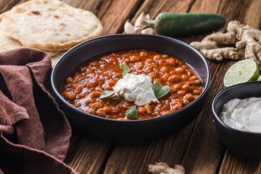 Chana Masala - Spicy chickpea curry served with chapatis. clipart