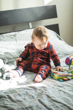 Surprised boy with pyramid and toys  in his hands clipart