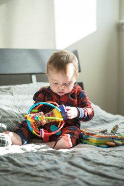 Surprised boy with pyramid and toys  in his hands clipart