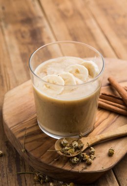 Hindistan cevizi kabında granola kaplı badem ezmeli smoothie kasesi. Sağlıklı vejetaryen gıda kavramı