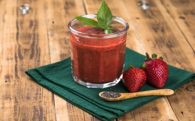Çilekli smoothie, chia tohumu ve taze fesleğen yaprağı. Sağlıklı yaz içeceği, vitamin ve antioksidan açısından zengin, temiz bir yaşam tarzı için mükemmel.