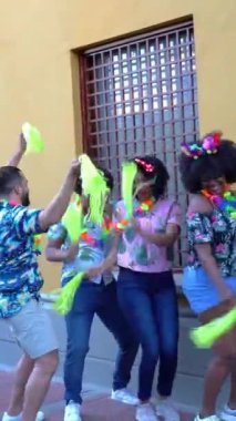 Happy group of friends dancing at a carnival party in Colombia.