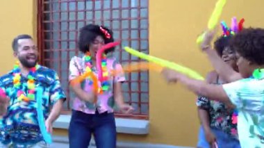 Friends having fun at the carnival in the street