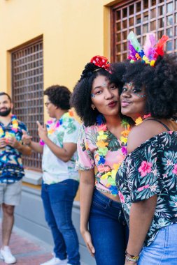 Two friends enjoying themselves during the annual carnival street parade.