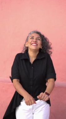Hispanic woman enjoys dancing in the street