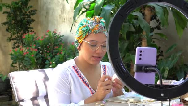 Latin Woman Filming Herself While Working Her Home Workshop — Vídeo de Stock