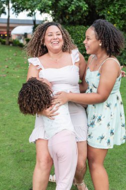 mother with her daughters smiling together.