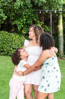 Mother with daughters enjoying a sunny day in the park