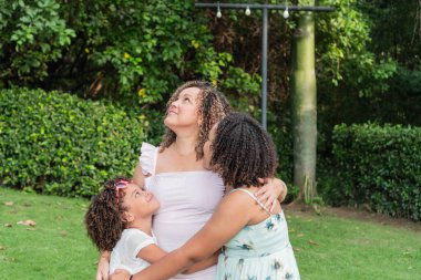 Latina mother with her two daughters spending a sunny day outdoors