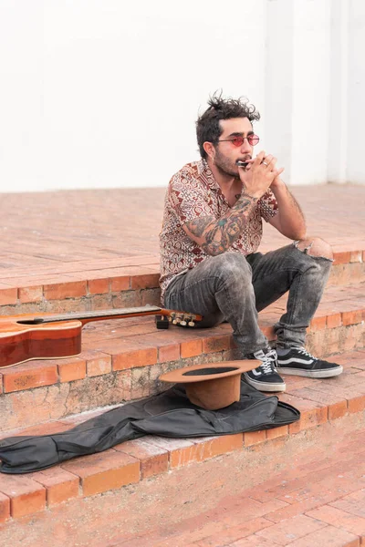 stock image Latin musician playing music on a staircase in the street