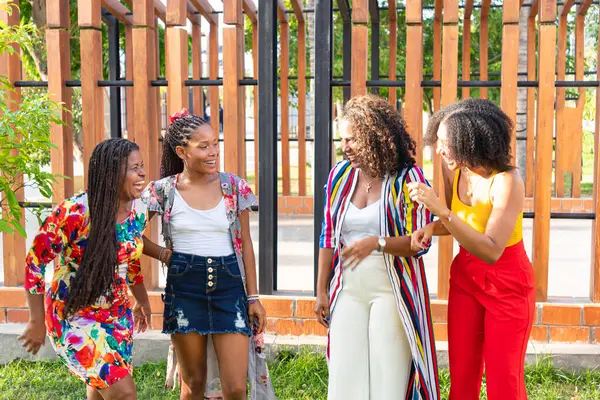 African descent women sharing a heartfelt hug outdoors