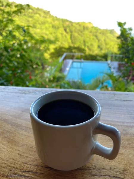 A cup of coffee with the mountains in the background