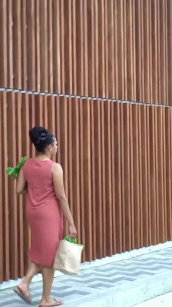Woman Coral Dress Carrying Greens — Stock Video