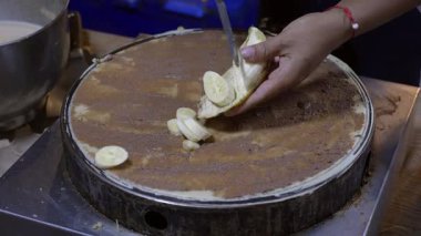 Satıcı muzlu ve çikolatalı ekmek yapıyor.