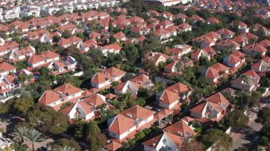 Kırmızı çatıları ve yeşil ağaçları olan klasik Suburban evleri.