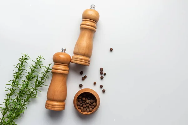 Two pepper mill on white background. Kitchen idea.