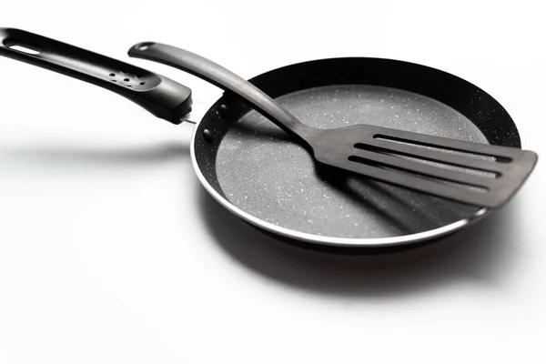 stock image Top view frying pan and plastic spade on white background.