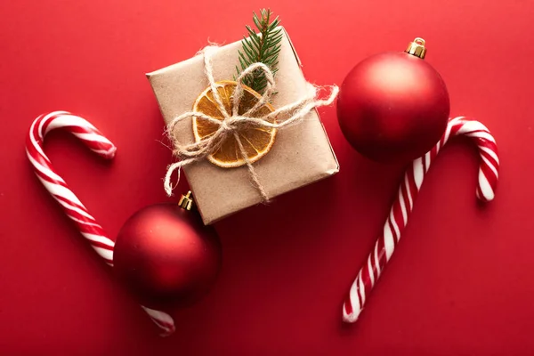 Stock image Christmas gift boxes wrapped kraft paper decorated ribbon bow and fir branches on marsala red background. Flat lay, top view. Christmas, winter holidays, New Year celebration concept