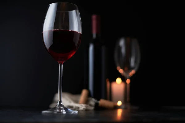 glass of red wine on a dark background. wineglass.