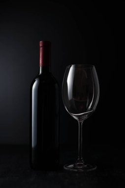 Wine glass and Bottle on dark background.