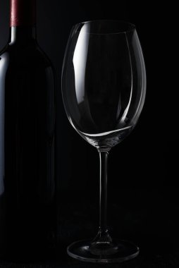 Wine glass and Bottle on dark background.