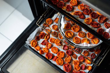 Tepsiler dolusu taze domates fırında kurutuluyor..