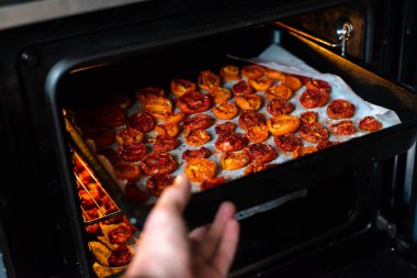 Tepsiler dolusu taze domates fırında kurutuluyor..