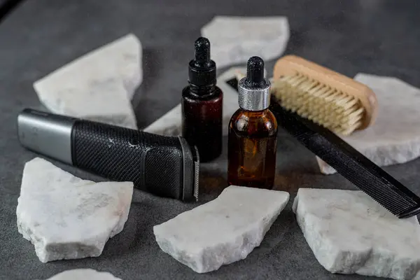 Beard oil with hair trimmer and comb.