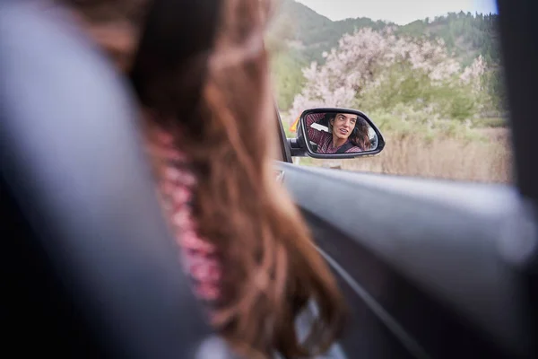 stock image pretty girl reflected in the car mirror while traveling