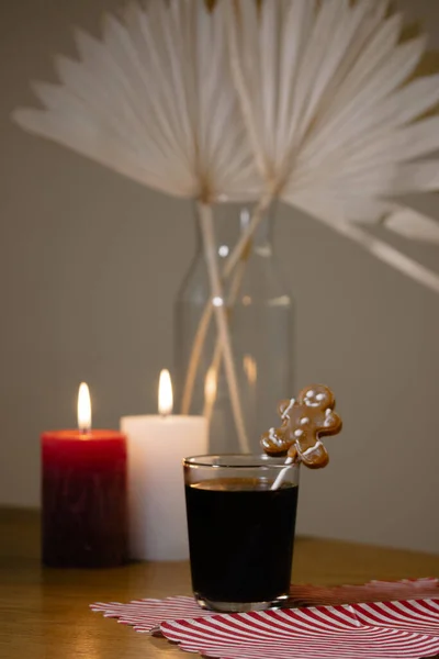 静谧的生活与一杯黑咖啡 茶或其他饮料装饰姜饼人饼干 燃烧的蜡烛 花瓶与家居装饰花的背景 平安夜庆祝气氛 — 图库照片