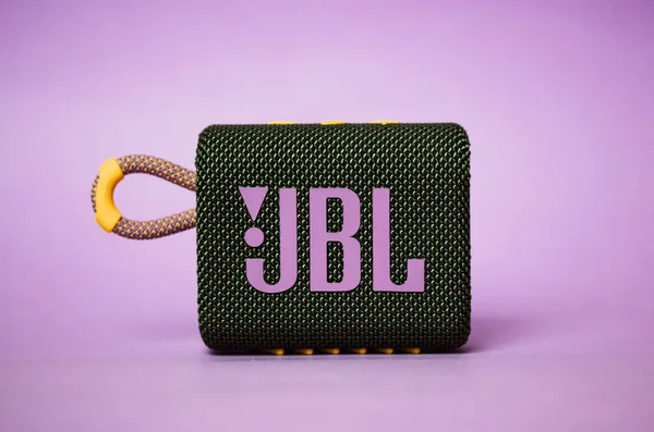 Kyiv, Ukraine. March 3, 2020. JBL GO 3 acoustic music speaker. Rectangular music playback speaker with purple JBL lettering on lilac background. Beautiful modern stylish musician equipment. A brand.