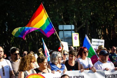 Madrid, Spain. July 20, 2022 Crowd of people on Pride Month. Sociedad at a march in defense of minority rights holding rainbow flags and posters in support of equality, equal rights, diversity freedom