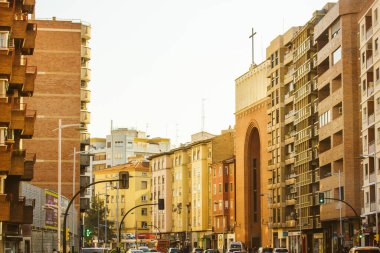 Zaragoza, Spain October 16, 2022 Autumnal city street Residential apartment houses, modern neighborhood. Multifamily buildings. Real estate. Suburb area. Asphalt road in distance with cars movement.