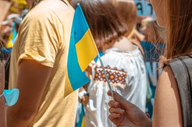 Madrid, Spain July 1, 2022 A crowd of activists with Ukrainian blue yellow flags at a peaceful protest against Russian aggression. Support for Ukrainians from the world community. Save Ukraine in war.