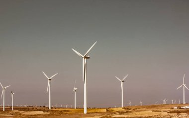 Zaragoza Spain May 1, 2022 Windmills against a blue sky and natural landscape. Renewable energy, ecology, energy production, alternative electricity. Green technology concept Windfarm white propellers