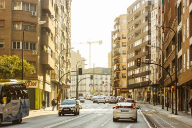 Zaragoza, Spain October 16, 2022 Autumnal city street Residential apartment houses, modern neighborhood. Multifamily buildings. Real estate. Suburb area. Asphalt road in distance with cars movement.