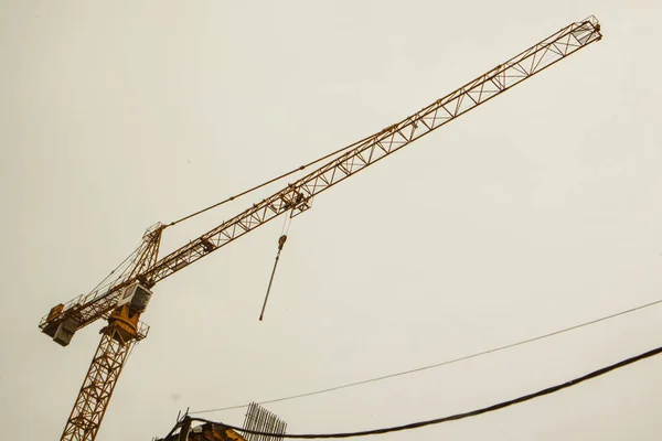 Construction mobile crane. Apartment building under construction. Investment in real estate. Development cities, megacities. Housing business concept. Hosting cranes high-rise. Lifting machinery.