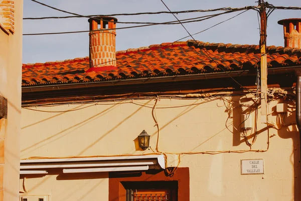 stock image Puebla de valles, Guadalajara, Spain. 7 March 2023 Old Mediterranean-style residential buildings facades. Yellow orange multicolored houses on a European street. Ancient architecture Scenic old street