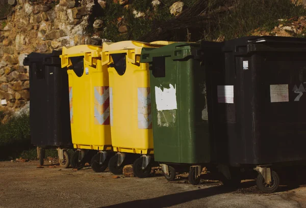 stock image Multicolored metal trash cans for sorting different types of trash on a city street. Row, group of many waste dumster outdoors. Ecological garbage containers. Separation, sorting trash. Recycling bins