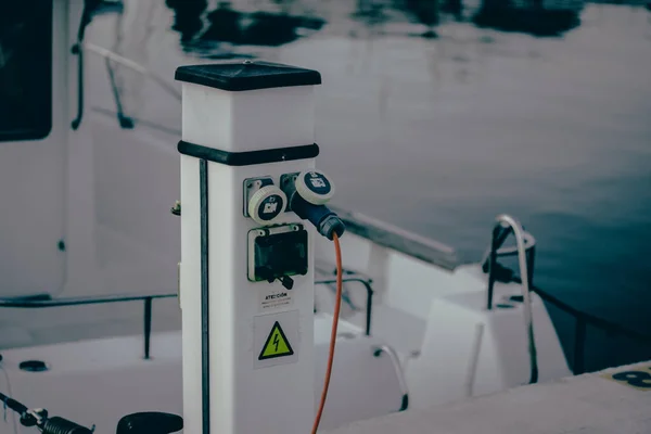 stock image Charging station with electrical outlets for yachts in a harbor. Power socket bollard on pier. Marina theme. Charger cables outdoors. A station for boats in boat station Luxury lifestyle travel voyage