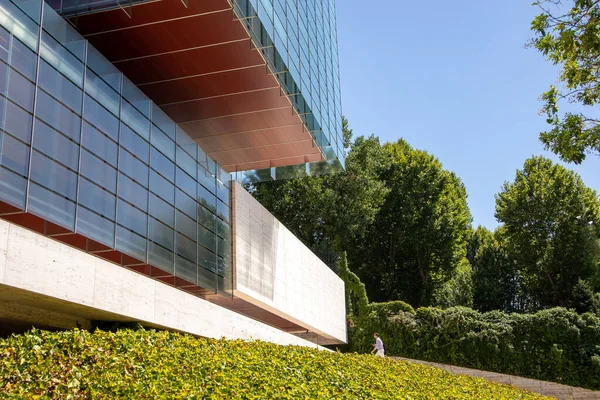 スペインのマドリード 2022年7月1日空に対する近代的な建物のガラスのファサード 都市中心部のペレス ロルカ社のオフィスビル 緑の茂みの木々の間の建築生態と持続可能性 — ストック写真