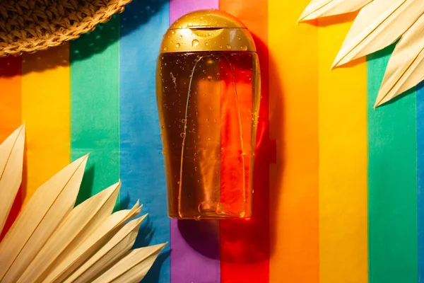 Suntan Oil Bottle Multicolored Striped Bright Rainbow Background Sunblock Cosmetics — Stock Photo, Image