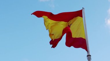 Madrid, İspanya. 22 Kasım 2023. Bayrak direğindeki büyük bir İspanyol bayrağı mavi gökyüzünde rüzgarda dalgalanıyor. Bir Avrupa ülkesinin bağımsızlığının sembolü. 