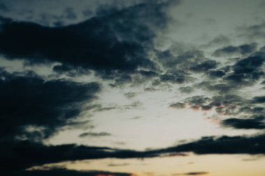 Karanlık, mavi, sarı, günbatımı gökyüzü. Alacakaranlıkta akşam bulutları. Son gün ışığı ve koyu mavi renkli karşıt bulutlarla dolu gökyüzü Majestic gökyüzü bulutu