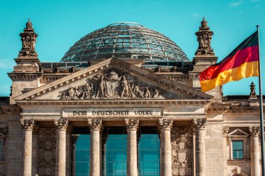 Berlin, Almanya. 2 Ekim 2022 Alman parlamento binası ve bayrak direğinde Alman bayrağı. Hükümet, politika konsepti. Sütunları olan eski bir bina. 